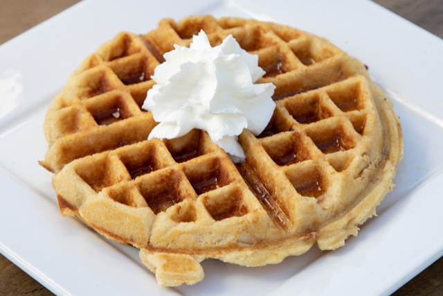 Buttermilk waffle with maple syrup and cream